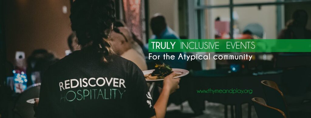 A server carries a tray of food. The words that read "Truly inclusive events for the atypical community"