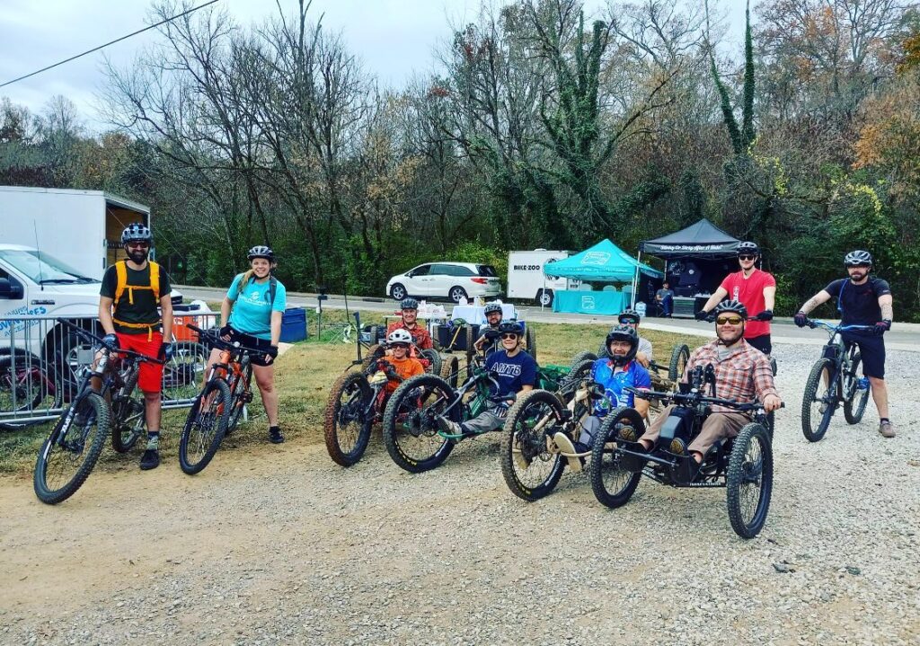  A group of off-road handcylists pose in a group prior to going on a ride.
