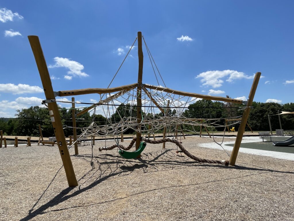 Photo of playground equipment named the Jungle Dome. It has logs and ropes from climbing, swings and other features.